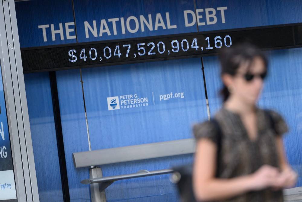 An electronic display shows the national debt in Washington, DC on Aug 19, 2026. The US national debt exceeded a record 40 trillion USD. - (Photo by MANDEL NGAN / AFP)
