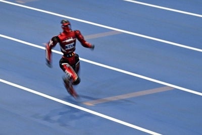 A humanoid robot competes on the first day of the 2nd World Humanoid Robot Games in Beijing on Aug 22, 2026. - (Photo by PEDRO PARDO / AFP)