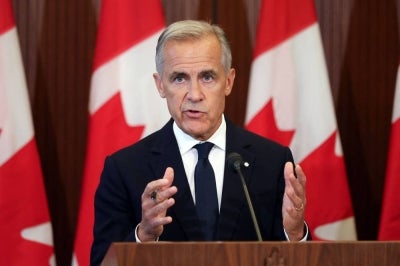 Canadian Prime Minister Mark Carney speaks at a press conference in Ottawa, Ontario on Aug 22, 2026 after trade talks with the US collapsed. - (Photo by Dave Chan / AFP)