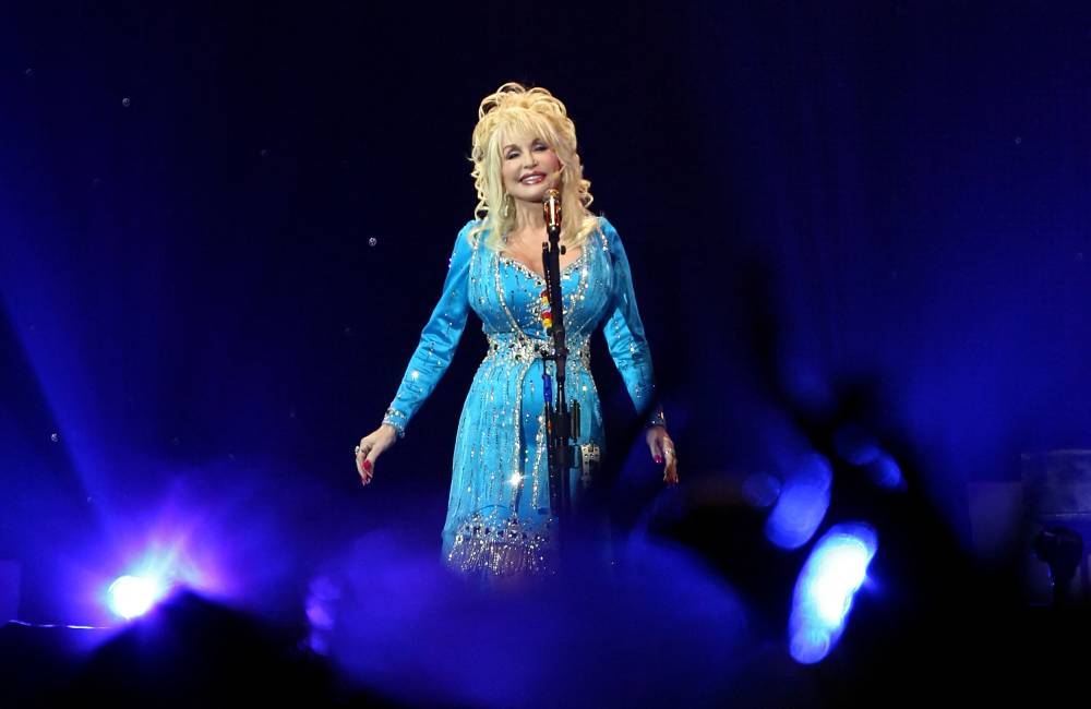 (FILES) US country music singer Dolly Parton performs onstage in London as part of her "Backwoods Barbie" world tour on July 5, 2008. Legendary US singer-songwriter and country music legend Dolly Parton has died at the age of 80, her family announced on August 25, 2026. (Photo by LEON NEAL / AFP)