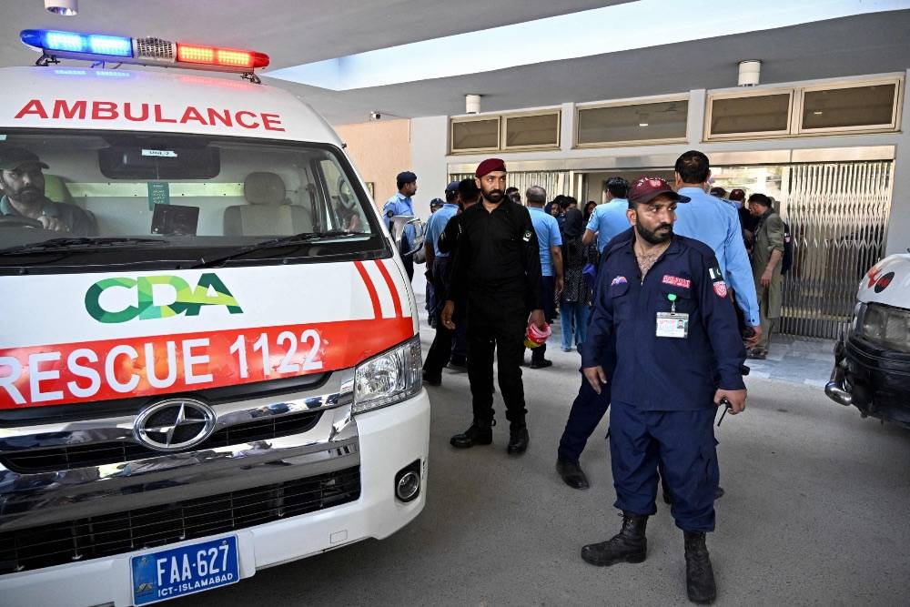 Security personnel stand next to an ambulance following a fire incident outside the Mother and Child Health (MCH) ward at the Pakistan Institute of Medical Sciences (PIMS) Hospital in Islamabad. Photo by AFP