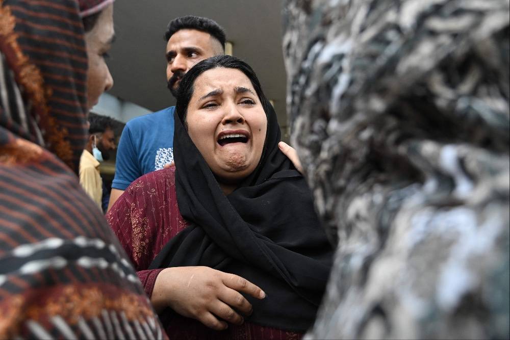 A mother reacts after the death of her child following a fire incident outside the Mother and Child Health (MCH) ward at the Pakistan Institute of Medical Sciences (PIMS) Hospital in Islamabad. Photo by AFP