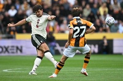 Manchester United's English defender #05 Harry Maguire (L) clears the ball during the English Premier League football match between Hull City and Manchester United at the MKM Stadium in Kingston upon Hull, eastern England on August 22, 2026. (Photo by Paul ELLIS / AFP)
