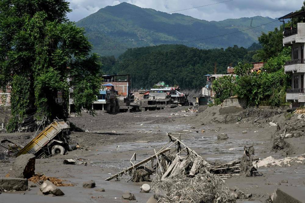 Houses lie deluged in sludge after flash floods at Trishuli Bazar in Nepal's Nuwakot district. Photo by AFP