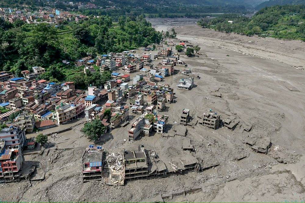 Houses lie deluged in sludge after flash floods at Trishuli Bazar in Nepal's Nuwakot district. Photo by AFP