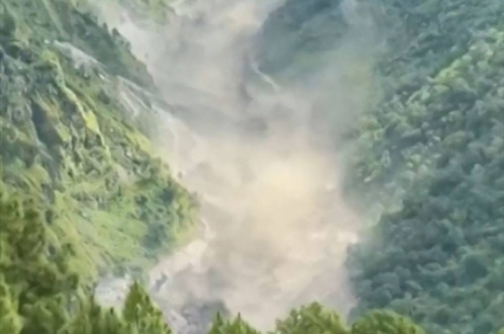 This frame grab from a UGC footage courtesy of Nepal Police shows floodwaters crashing through the Bhote Koshi River after flash floods in Rasuwa district. Photo by -UGC/Nepal Police/AFP