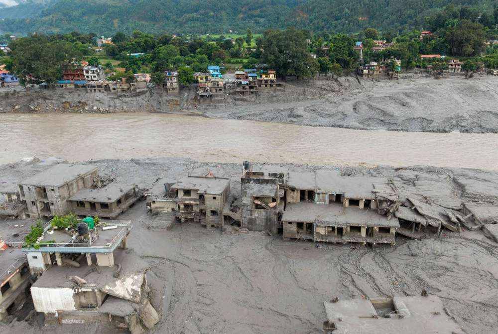 An aerial view shows houses lying deluged in sludge after flash floods at Devighat, Bidur Municipality in Nepal's Nuwakot district on Aug 27, 2026. - (Photo by PRABIN RANABHAT / AFP)