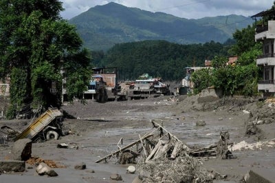 Houses lie deluged in sludge after flash floods at Trishuli Bazar in Nepal's Nuwakot district. Photo by AFP