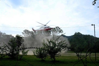 An army helicopter carrying victims lands at a hospital following flash floods in Nepal's Nuwakot district. Photo by AFP