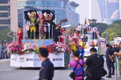 The tourism sector contingent marches in during the full rehearsal for the 2026 National Day Celebration at Dataran Putrajaya today. - Photo by Bernama