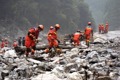 Fire and rescue personnel conduct search and rescue operations 2 kilometers from Gyirong Port days after the August 26 mudslide which destroyed the port, in Gyirong County, in China, western Tibet region. Photo by AFP