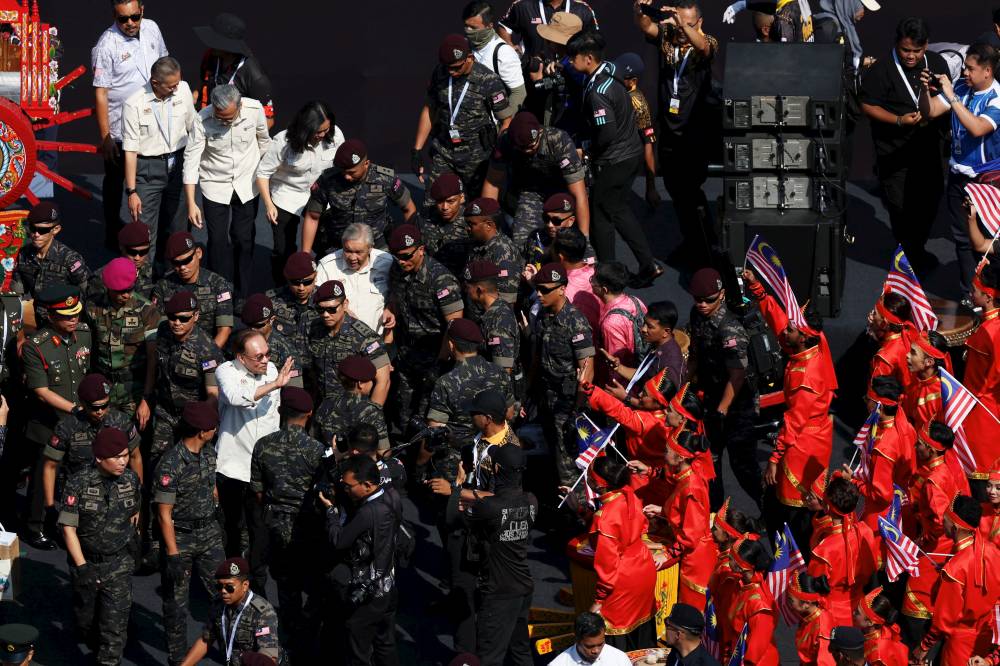 Prime Minister Datuk Seri Anwar Ibrahim mingles with the participants of the performance at the 2026 National Day Celebration at Dataran Putrajaya today. (BERNAMA PHOTO)