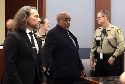 Duane Davis (C) and his attorney Michael Sanft are led back to a courtroom to hear his sentencing date after a jury found Davis guilty in the 1996 killing of rapper Tupac Shakur, at Clark County District Court at the Regional Justice Center in Las Vegas, Nevada, on Aug 31, 2026. - (Photo by Bizuayehu Tesfaye / POOL / AFP)