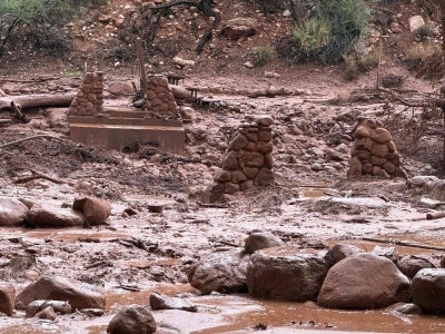 Remnants of stone bridge pylons along Bright Angel Creek following a flash flood that destroyed the footbridge on Aug 29. Photo by AFP/National Park Service