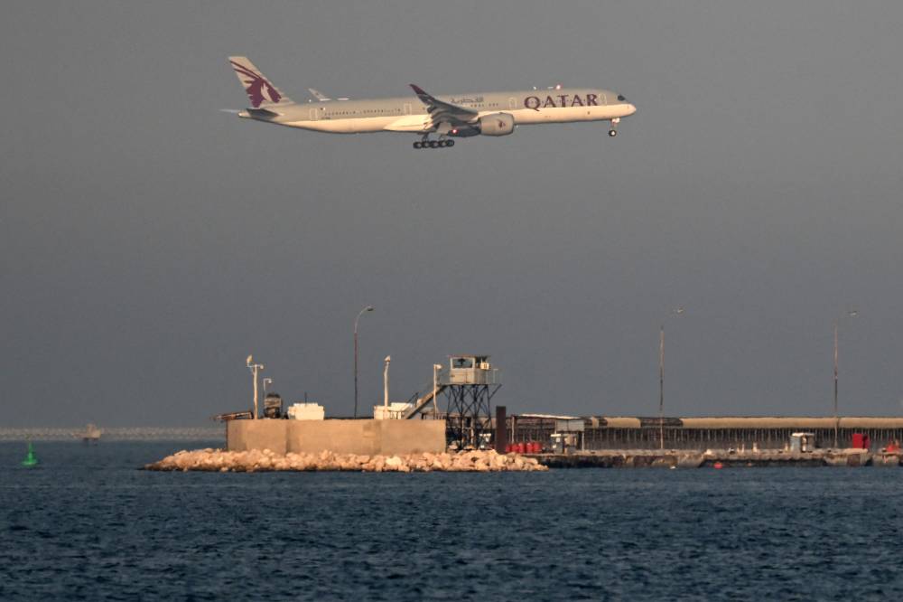 A Qatar Airways passenger aircraft lands at Hamad International Airport in Doha on Aug 30, 2026. - (Photo by Mahmud HAMS / AFP)