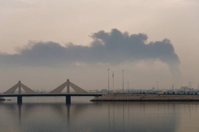 A plume of smoke rises after a reported Iranian strike on fuel tanks in Muharraq on March 12, 2026. - (Photo by Fadhel MADHAN / AFP)