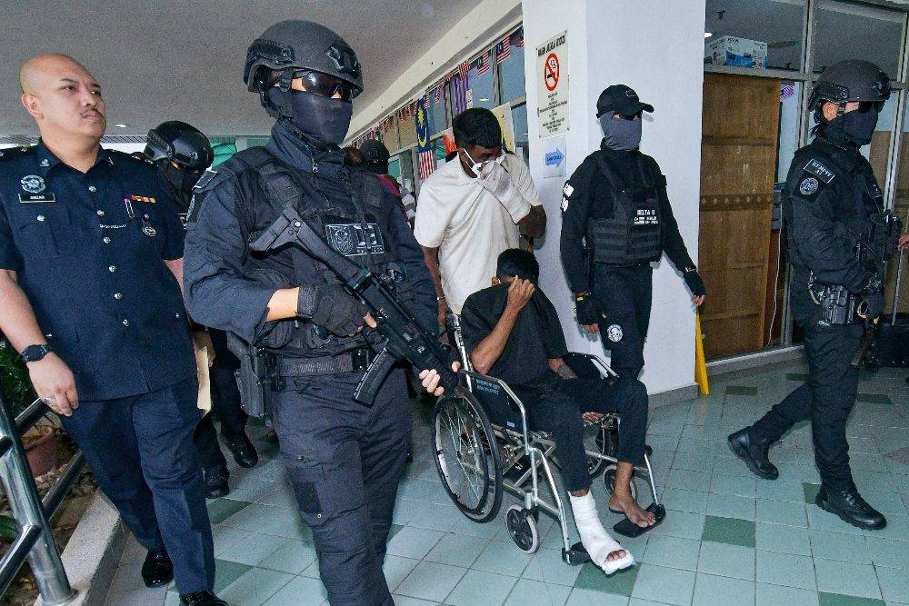 Eight men, including two alleged secret society members, were charged at the Magistrate’s Court here today with the murder of a man during a brawl involving a group of individuals in Taman Alam Megah last month. Photo by Bernama