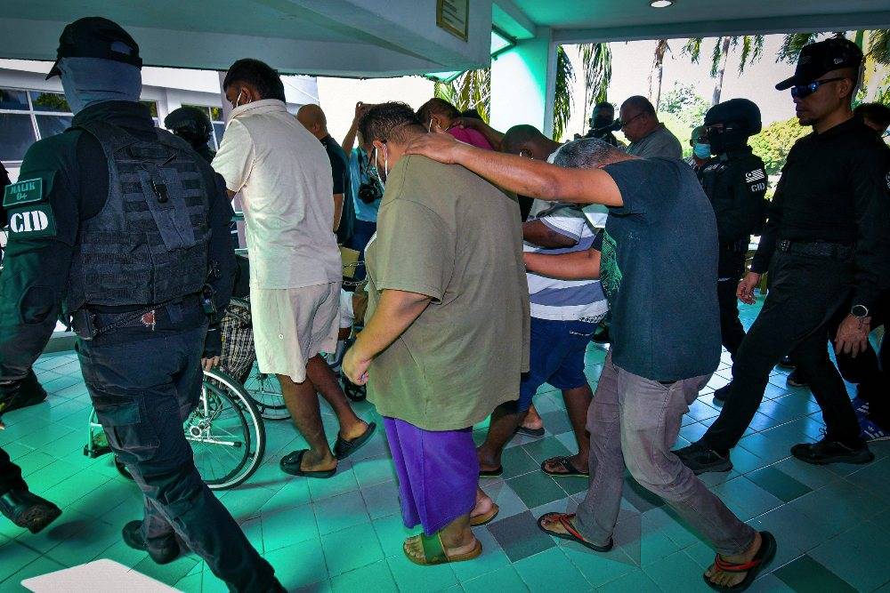 Eight men, including two alleged secret society members, were charged at the Magistrate’s Court here today with the murder of a man during a brawl involving a group of individuals in Taman Alam Megah last month. Photo by Bernama