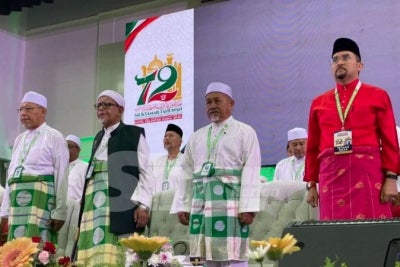 Umno secretary-general Datuk Dr Asyraf Wajdi Dusuki representing president Datuk Seri Ahmad Zahid Hamidi at the 72nd Pas Annual Muktamar at Pusat Tarbiah Islamiah Kelantan in Pengkalan Chepa, Kota Bharu, on Friday. - Photo by HAZELEN LIANA KAMARUDIN