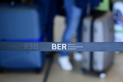 The airport logo is seen on a cordon at the Berlin Brandenburg BER airport Willy-Brandt in Schoenefeld, southeast of Berlin, on Sept 20, 2025. - (Photo by TOBIAS SCHWARZ / AFP)