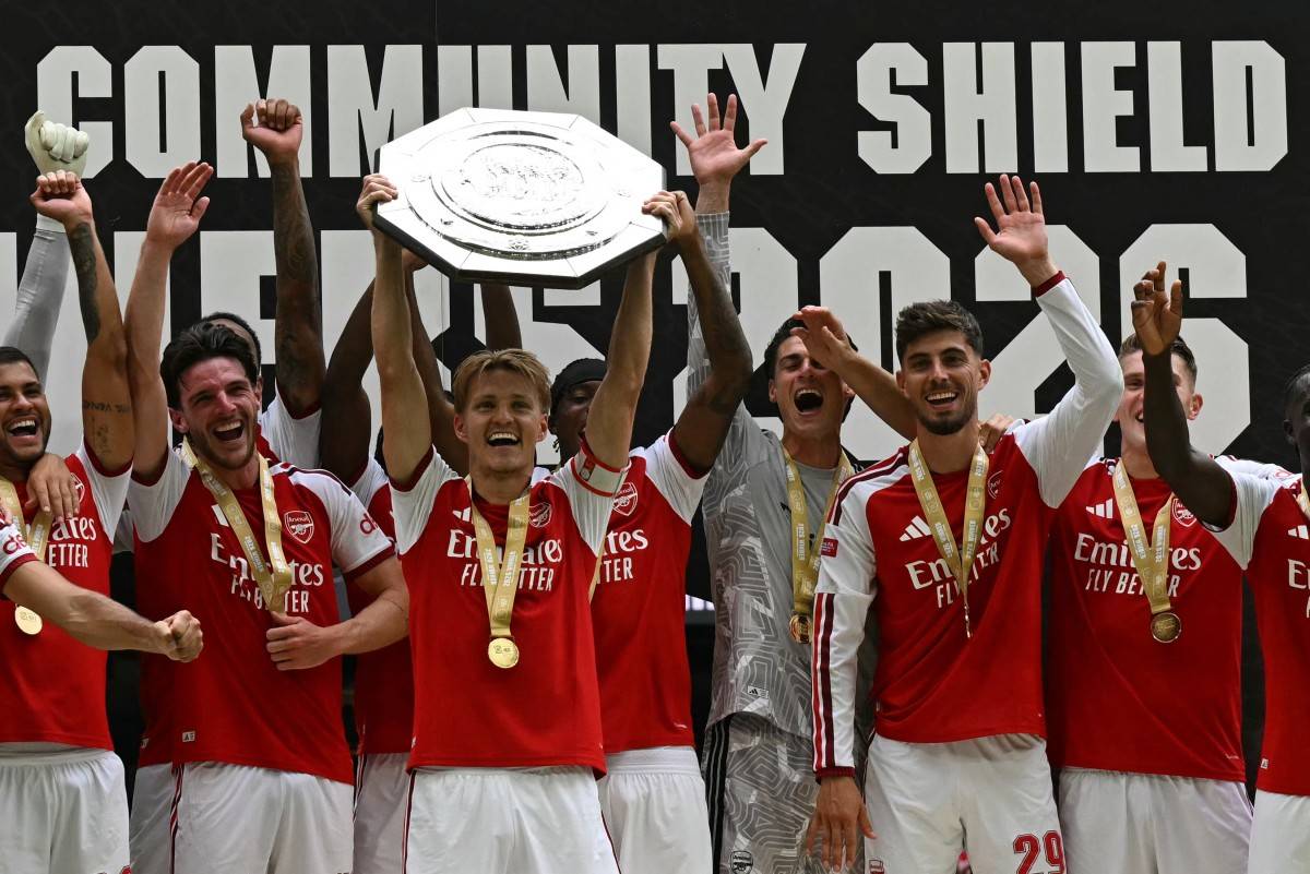 Arsenal's Norwegian midfielder #08 Martin Odegaard lifts the trophy as Arsenal's players celebrate their victory after the English FA Community Shield football match between Arsenal and Manchester City at The Principality Stadium, in Cardiff, south Wales on August 16, 2026. Arsenal won the game 3-0. AFP FILE PIX