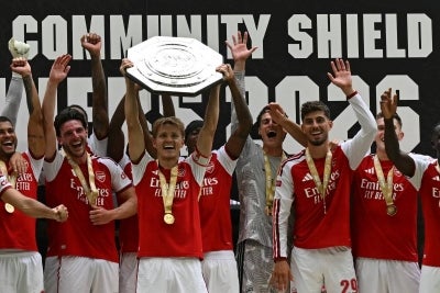 Arsenal's Norwegian midfielder #08 Martin Odegaard lifts the trophy as Arsenal's players celebrate their victory after the English FA Community Shield football match between Arsenal and Manchester City at The Principality Stadium, in Cardiff, south Wales on August 16, 2026. Arsenal won the game 3-0. AFP FILE PIX