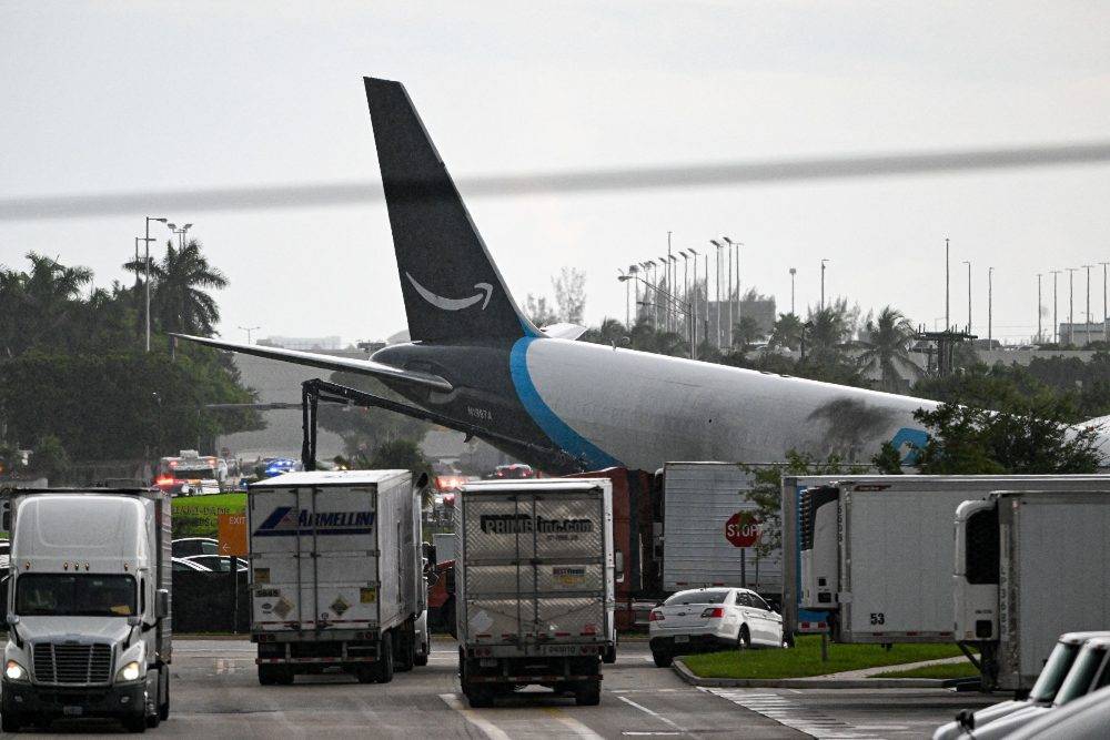 The tail section of a cargo plane is seen at Miami International Airport after it overran the runway at Miami International Airport in Miami, Florida. Photo by AFP