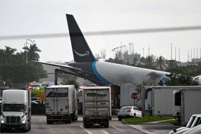 The tail section of a cargo plane is seen at Miami International Airport after it overran the runway at Miami International Airport in Miami, Florida. Photo by AFP