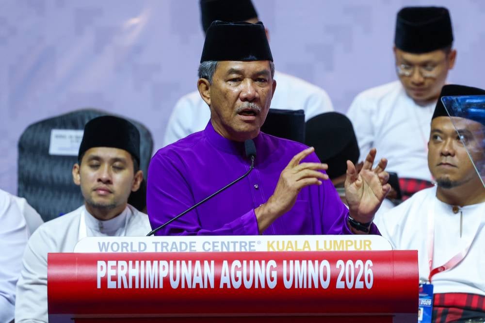 Umno deputy president Datuk Seri Mohamad Hasan delivers his speech at the opening ceremony of the Wanita, Youth and Puteri Umno wing general assemblies in conjunction with the 2026 Umno General Assembly at Dewan Merdeka, World Trade Centre Kuala Lumpur, today. - Photo by Bernama