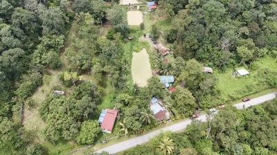 
Photo by Syahrin Khairi Drone shot
of Sitam Ali's 1.5-acre land and surrounding properties set to be acquired for the bypass project. 