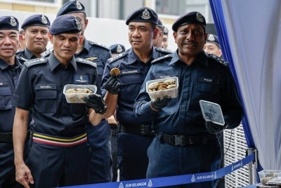 Bukit Aman Narcotics Criminal Investigation Department (NCID) director Datuk Hussein Omar Khan (right) displays seized items at a press conference on NCID's success in uncovering an illegal drug-processing lab and dismantling a local and international drug trafficking syndicate worth RM2.41 billion, at Jalan Eko Perindustrian, Puncak Alam, today. - Photo by Bernama