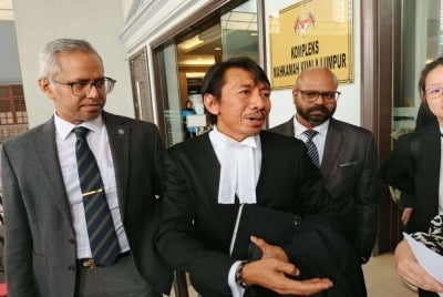 Datuk Seri Abdul Azeez Rahim's lawyer, Datuk Amer Hamzah Arshad speaks to reporters at the lobby of the Kuala Lumpur Court Complex on Wednesday.
