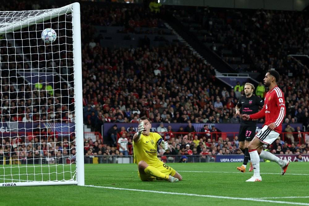 Manchester United's Brazilian striker #10 Matheus Cunha scores the team's first goal past Sabah FK's Kazakhstani goalkeeper #92 Stas Pokatilov during the UEFA Champions League football match between Manchester United and Sabah FK at Old Trafford in Manchester, north west England. Photo by Darren Staples/AFP