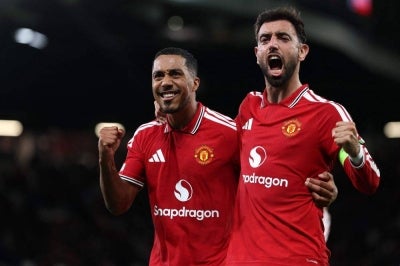 Manchester United's Portuguese midfielder #08 Bruno Fernandes celebrates scoring the team's second goal with Manchester United's Belgian midfielder #18 Youri Tielemans (L) during the UEFA Champions League football match between Manchester United and Sabah FK at Old Trafford in Manchester, north west England. Photo by Darren Staples/AFP