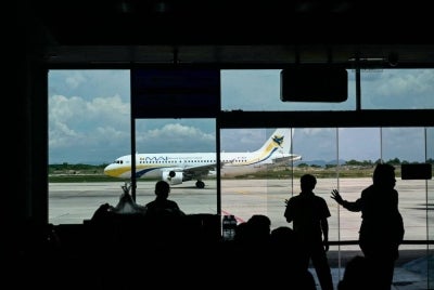 (FILES) A Myanmar Airways International passenger plane is parked at the Mandalay International Airport in Mandalay on Sept 18, 2025. Myanmar's second-busiest airport was closed for two days on Sept 11, 2026, security sources told AFP, after the military-backed government accused pro-democracy rebels of attacking it with drones. - (Photo by Sai Aung Main / AFP)