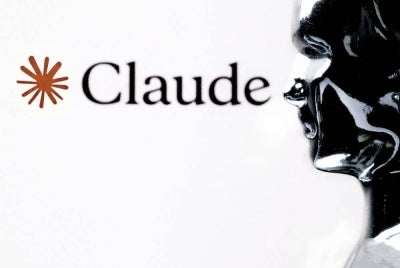 This photograph shows a figurine in front of the logo of the AI assistant "Claude" built by the US artificial intelligence safety and research company Anthropic during a photo session in Paris on Feb 13, 2026. -(Photo by JOEL SAGET / AFP)