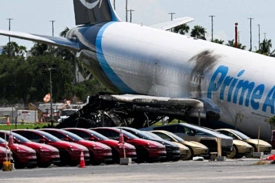 An Amazon cargo plane overshot a runway as it landed in Miami, crashing into vehicles and catching fire. - AFP FILE PIX