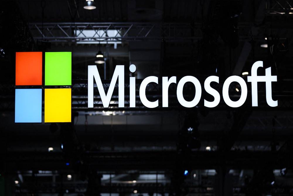 The logo of Microsoft is seen during the opening of the Hannover Messe industrial trade fair for mechanical and electrical engineering and digital industries, on March 31, 2025 in Hanover, northern Germany. - (Photo by RONNY HARTMANN / AFP)