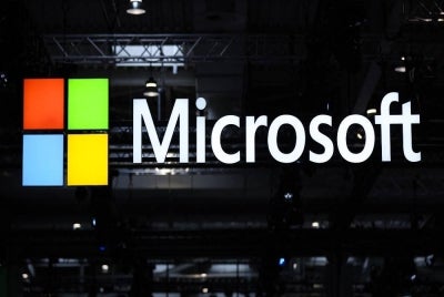 The logo of Microsoft is seen during the opening of the Hannover Messe industrial trade fair for mechanical and electrical engineering and digital industries, on March 31, 2025 in Hanover, northern Germany. - (Photo by RONNY HARTMANN / AFP)