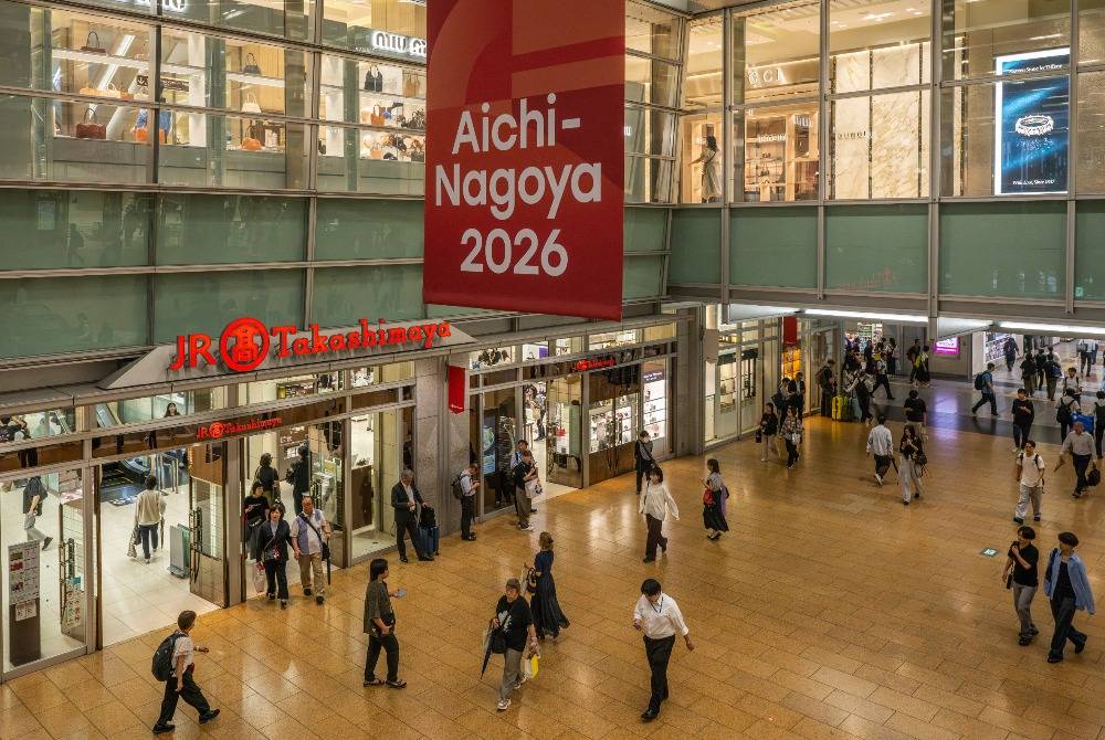 People walk under a banner promoting the 2026 Asian Games at the train station in Nagoya, Aichi Prefecture on Sept 16, 2026. - (Photo by Mohd Rasfan / AFP)