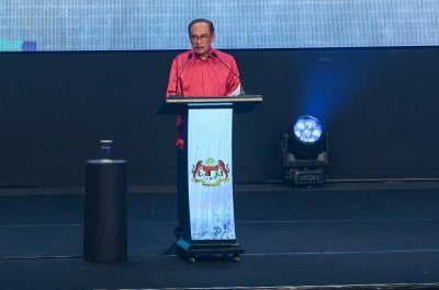 Prime Minister Datuk Seri Anwar Ibrahim delivers his speech at the 2026 National-level Malaysia Day celebration at the Borneo Convention Centre Kuching, last night. - Photo by Bernama