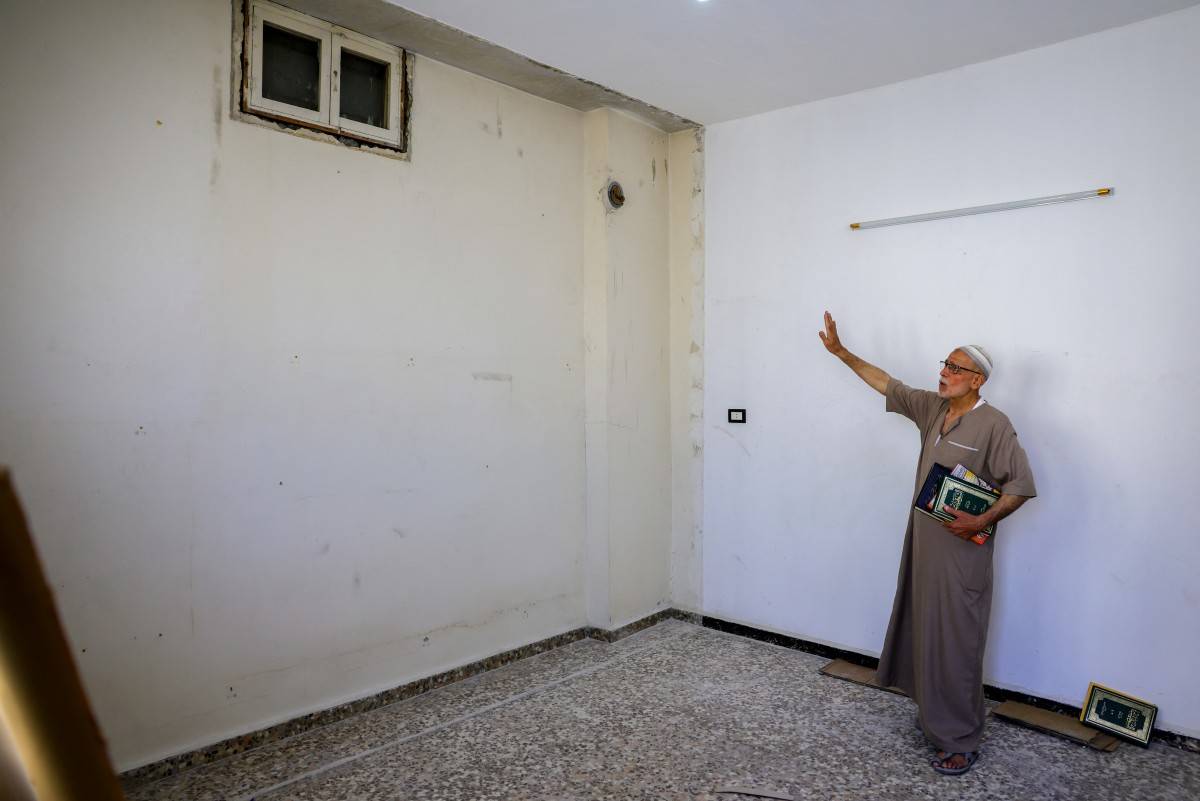 Mustafa Khaled Alwan, a 72-year-old Syrian man, points at what was a false wall where he hid his books for 15 years at the start of the uprising against longtime Syrian ruler Bashar al-Assad, in his home in the al-Bayadah neighbourhood in Homs on September 19, 2026. (Photo by Bakr ALKASEM / AFP)
