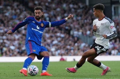 Manchester United's Portuguese midfielder #08 Bruno Fernandes (L) vies with Fulham's English midfielder #24 Josh King (R). Photo by AFP