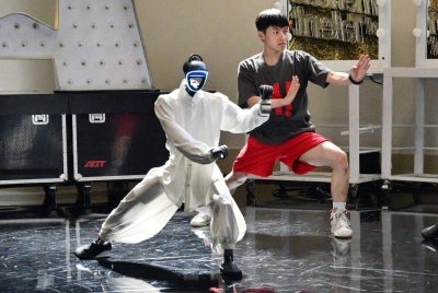 Chinese street dancer Wu Yufei and a Unitree Robotics humanoid robot mimic Tai Chi-like poses during a demonstration in Pasadena, California ahead of their performance in the Season 21 finals of "America's Got Talent". Unitree's humanoid robots have attracted international attention for their increasingly advanced and acrobatic capabilities, including backflips, Kung Fu and other performances. The Chinese robotics company's machines are set to appear on the US television talent show "America's Got Talent" on September 22, 2026. -AFP Photo