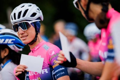 Afghan Cyclist Fariba Hashimi (L). (Photo by VALENTIN FLAURAUD / AFP)