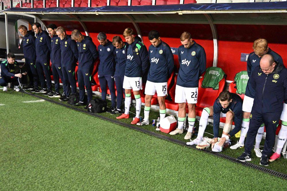 Members of the Republic of Ireland team stand with their heads bowed at the bench as the Israeli national anthem is played before the UEFA Nations League Group B3 between Israel and Republic of Ireland in Debrecen, Hungary. -AFP PIX