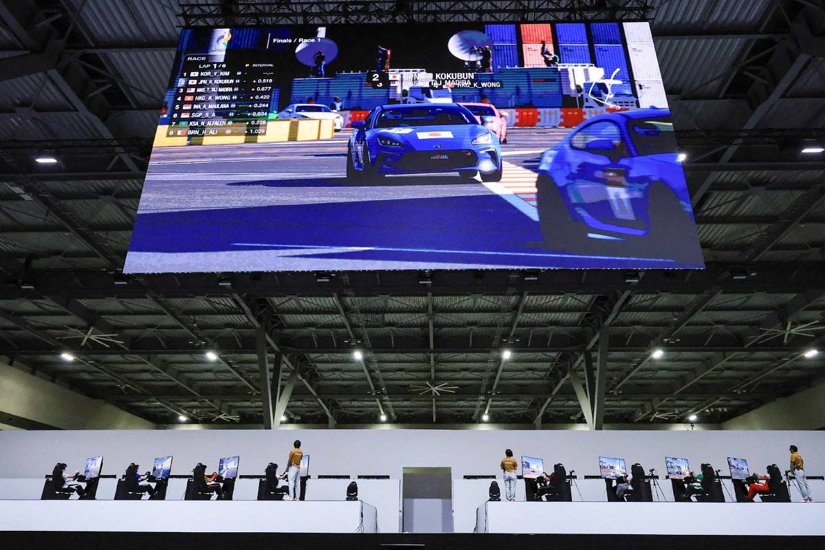 Athletes compete in the "Gran Turismo 7" esports final at the Aichi Sky Expo during the 2026 Asian Games in Tokoname City, Aichi Prefecture on September 23, 2026. (Photo by JIJI Press / AFP) / Japan OUT