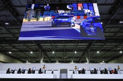 Athletes compete in the "Gran Turismo 7" esports final at the Aichi Sky Expo during the 2026 Asian Games in Tokoname City, Aichi Prefecture on September 23, 2026. (Photo by JIJI Press / AFP) / Japan OUT