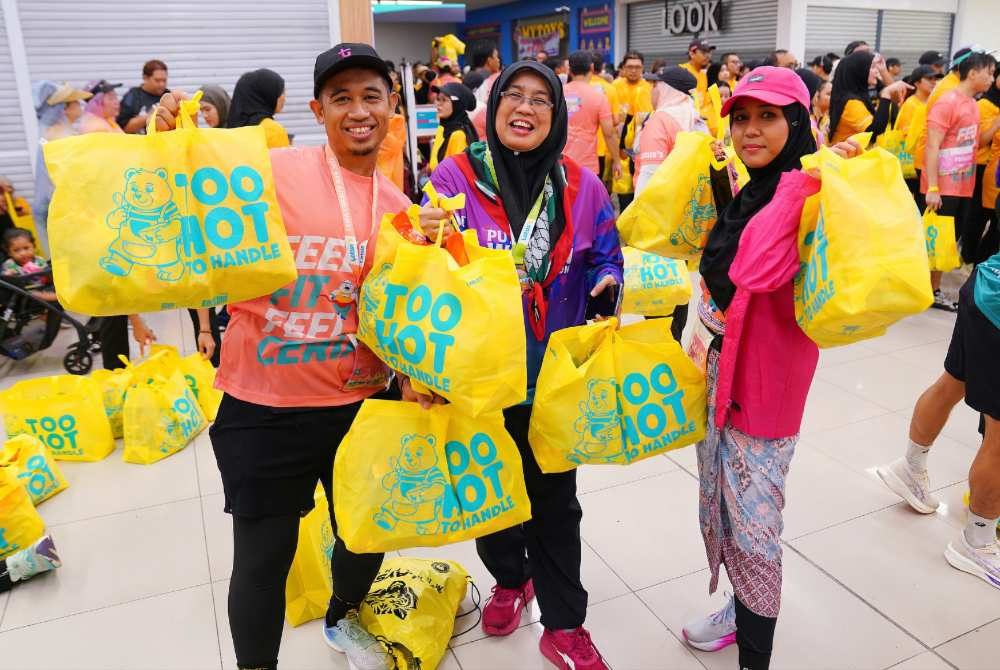 While the charity run had a clear focus on education, the introduction of the half marathon also gave runners a new challenge. - Photo by MOHD HALIM ABDUL WAHID