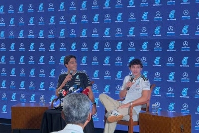 George Russell (left) with teammate Kimi Antonelli. - Sinar Daily photo